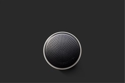 Black Wireless Bluetooth Speaker Isolated on Plain Black Background, Viewed From Above; Top View Showing Perforated Metal Grille Holes.