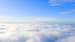 Aerial view White clouds in blue sky. Top. View from drone. Aerial bird's eye. Aerial top view cloudscape. Texture of clouds. View from above. Sunrise or sunset over clouds