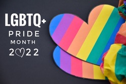 Rainbow heart with texts 'LGBTQ+ Pride Month 2022' on black background, concept for lgbtq+ celebrations in pride month, June, around the world.