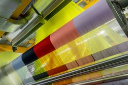 weaving loom at a textile factory, closeup. industrial fabric production line