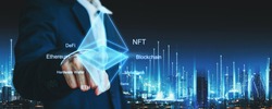 NFT crypto currency ethereum technology concept, Professional business man pointing ETH icon and blockchain network on futuristic city at night in Bangkok, Thailand