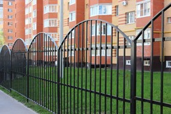 black metal fence in front of urban apartment building