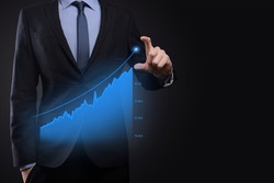 Business man holding holographic graphs and stock market statistics gain profits. Concept of growth planning and business strategy. Display of good economy form digital screen