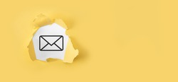 Torn yellow paper with letter email icon on white background.Email marketing and newsletter concept. Contact us by newsletter email and protect your personal information from spam mail concept.