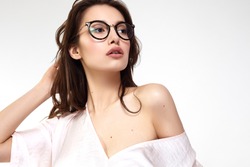 Female Eye wear. Attractive Brunette Girl With Natural Face Makeup In Transparent Glasses Frame.
