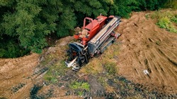 Horizontal directional drilling technology. Aerial view of Drilling machine work process. Trenchless laying of communications, pipes and water pipes. Selective focus