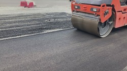 Repair new road asphalting roller. Applying hot resin sidewalk. Industrial equipment with smooth rolling pressure leveling asphalt. Worker building road in city. Smoothing construction highway surface