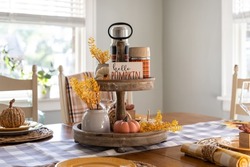 Autumn table decorations in a light and bright dining room decorated for fall
