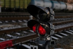 Railway traffic light on rails. Red light is on