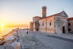 Madona cape with saint Clement church in Piran town at the sunset in Slovenia