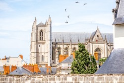 City scape view on the beautiful saint Pierre cathedral with birds flying in Nantes city in France