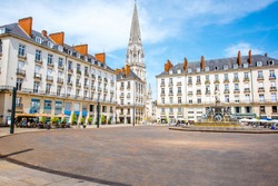 View on the Royal square with fountain and church tower in Nantes city in France