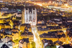 Aerial cityscape view with illuminated buildings and saint Pierre cathedral in Nantes city during the night in France