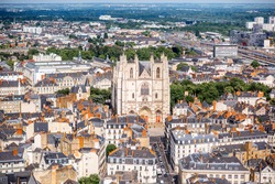 Aerial cityscape view with beautiful buildings and saint Pierre cathedral in Nantes city during the sunny weather in France