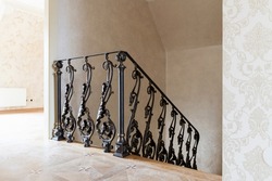 wooden stairs with metal wrought iron railings in a new house