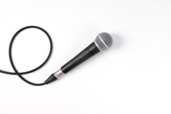 Close up of high quality dynamic microphone connect with male xlr connector and  cable isolated on white background,top view.
High fidelity microphone on white background with clipping path .

