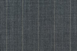 Close up of pinstriped fabric texture for garment manufacturing in grey color.
Wool textile for suiting.