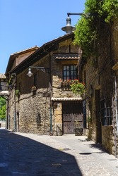 Vertical panoramic view of spanish ancient architecture in Navarre. Exterior facade of stone house in Spain.