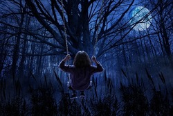Girl swinging in a terrifying forest