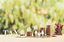 Family members, house, dollar money bags on rows of rising coins. Concept family tax benefit, residential property or estate taxt depicts home equity loan, reverse mortgage