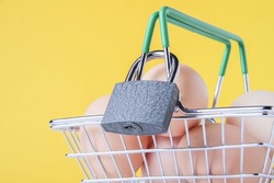 Ban on the sale of chicken eggs. Sanctions. Basket with groceries a closed lock