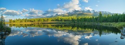 Picturesque mountain lake in the summer morning, Altai. Beautiful reflection of mountains, sky and white clouds.