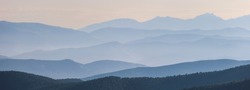 Mountains in the morning haze. Panoramic view. Natural blue background.