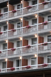 Empty hotel balconies with flowers and lights on in Bled