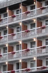 Empty hotel balconies with flowers and lights on in Bled