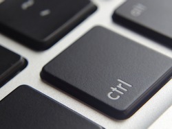Black control button close-up with other keyboard buttons in background