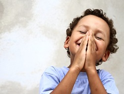 little boy praying to God with hands together and a smile on his face with head held high stock image stock photo 