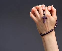 hand holding cross praying to god stock photo 