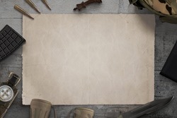 Blank military map on desk surrounded by army equipment