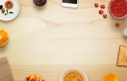 Breakfast scene with free space, tablecloth, fruits, toast, jar of jam, phone, cutting board on table. Top view.