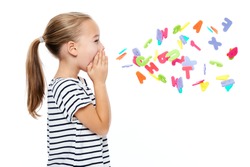 Cute little girl in stripped T-shirt shouting out alphabet letters. Speech therapy concept over white background.