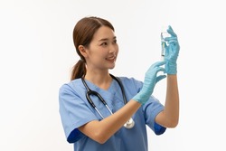 Portrait of young Asian female doctor drawing Covid-19 vaccine from vaccine bottle, with syringe and stethoscope, isolated on white backround, Covid-19 vaccination concept