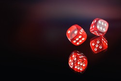 The dice fall on a dark red background. Soft tinted image. Casino gambling poker, roulette.