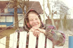 Portrait of an Elderly Woman in a Village. Retro Concept