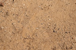 Sand and glass background. Texture ground, dirt, glass background.