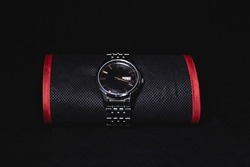 Nice luxury man's wrist watch on dark background. Stainless steel man's wrist watch with black leather strap.