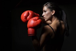 beautiful woman with the red boxing gloves,black background