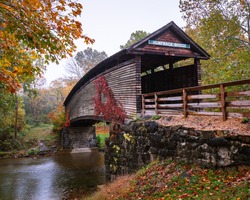 Humpback covered bridge in Alleghany County, Covington, Virginia is the oldest covered bridge in the state. This was captured during the onset of fall colors on an overcast drab day.