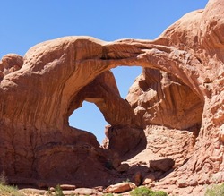 Double Arch in Arches National Park Utah America. Remarkable Landmark.
Natural stone Arch in front of Blue Sky.
Natural formed Red Stone.
High Resolution in Poster format.