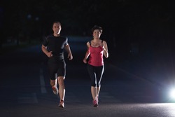 urban sports, healthy couple jogging in the city at early morning in night