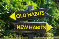 Old Habits - New Habits signpost with forest background