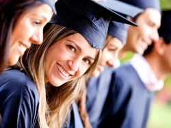 Woman standing out from a graduation group smiling
