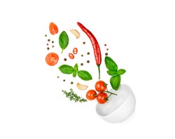 Tomato, basil, spices, chili pepper, garlic fresh thyme flying. Vegan diet food isolated on white. Falling into bowl, levitation fly. Creative concept. High quality photo