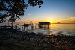 Long Exposure Shot of long fishing pier at Sunrise located at Tanjung Langsat, Johor, Malaysia