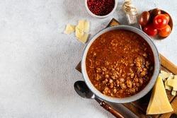 classic italian bolognese sauce with ingredients on light background. Bolognese sauce top view. culinary background with space for text. Pasta bolognese. Italian lasagna