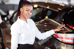 Car dealer woman. Auto dealership and rental concept background.